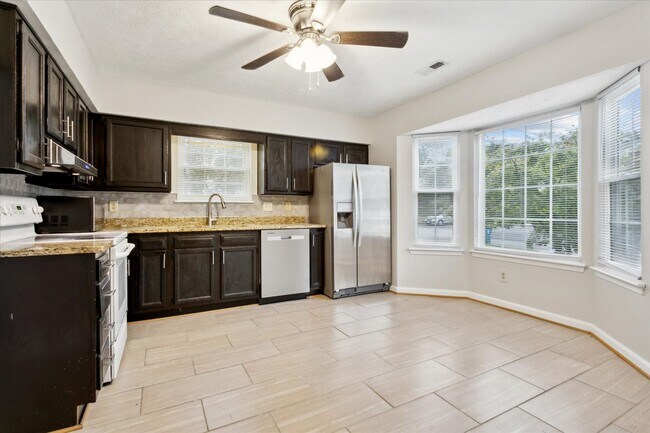 Great eat in kitchen features granite countertops, tons of cabinet space, and a pantry! - 1644 Skiffes Creek Cir