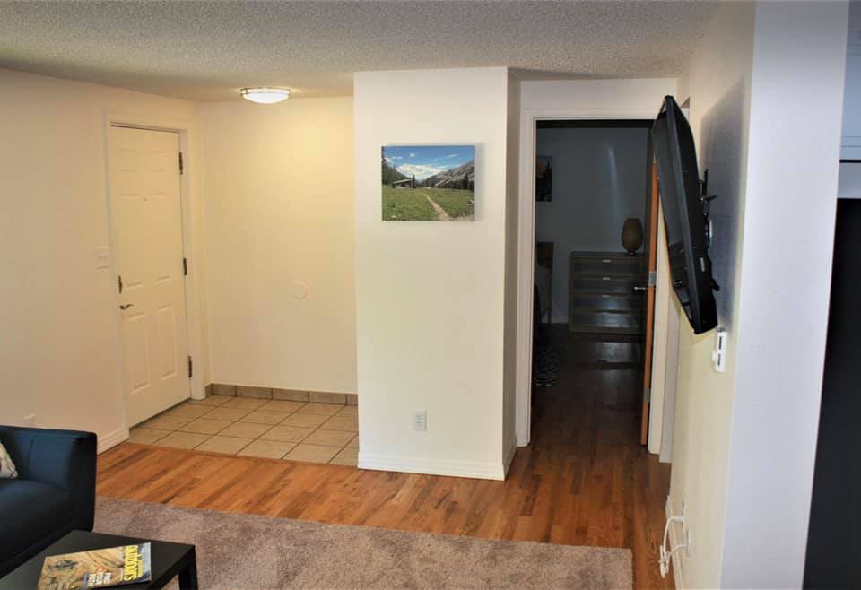 View from living room towards front door and front bedroom - 1228 Maple Street