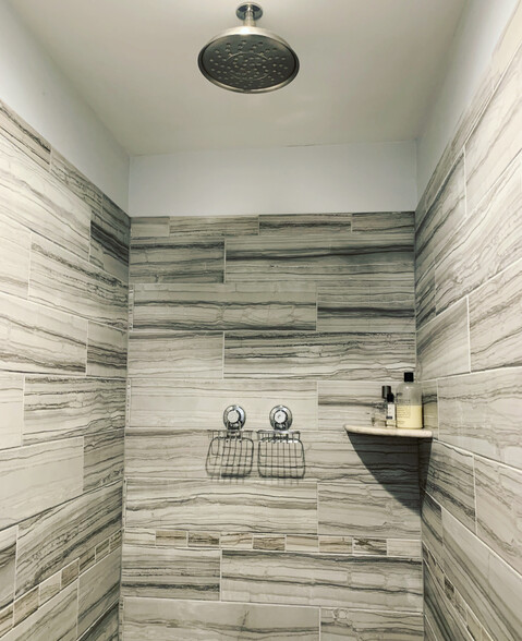 Large tiled shower stall with rain shower head. - 74 Peters Pl