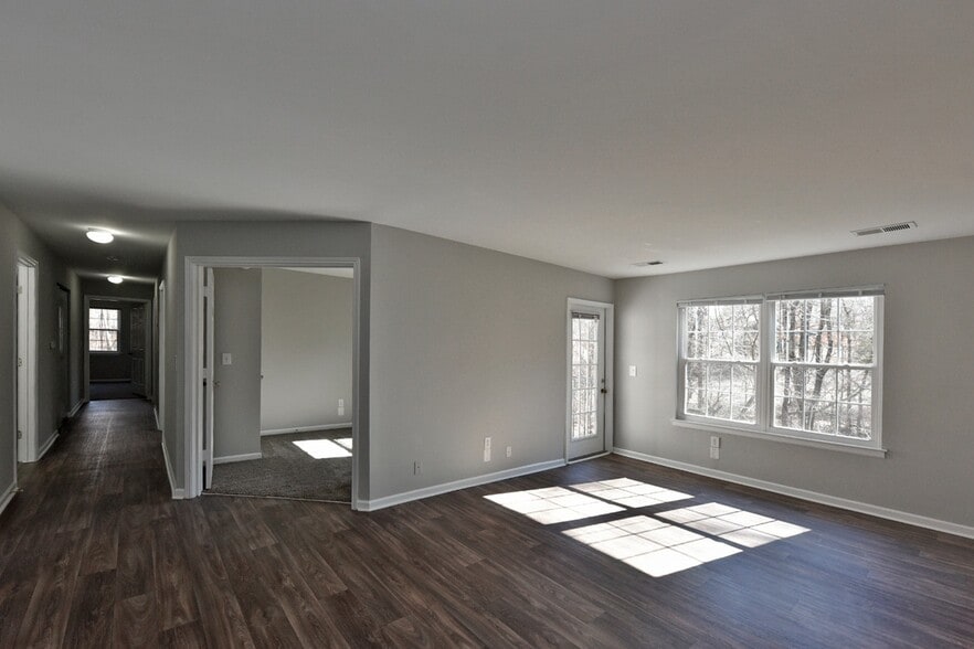 Spacious living room with hardwood-style flooring - Parc Fairview