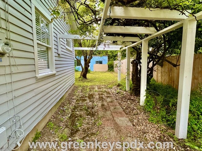 Building Photo - This 3-bedroom 1-bathroom house has a large front yard and a mostly fenced backyard.