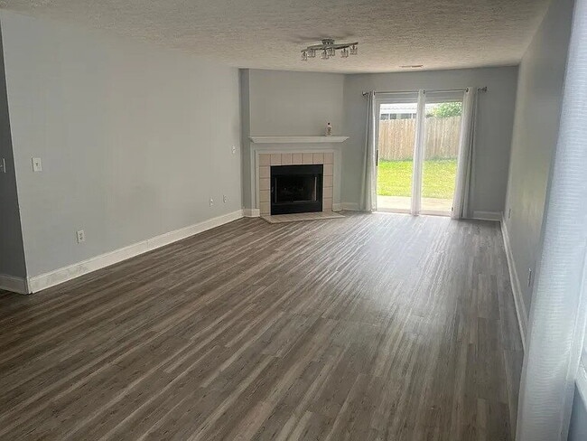 Building Photo - The home features beautiful LVP flooring, granite countertops, stainless steel appliances, and a ...