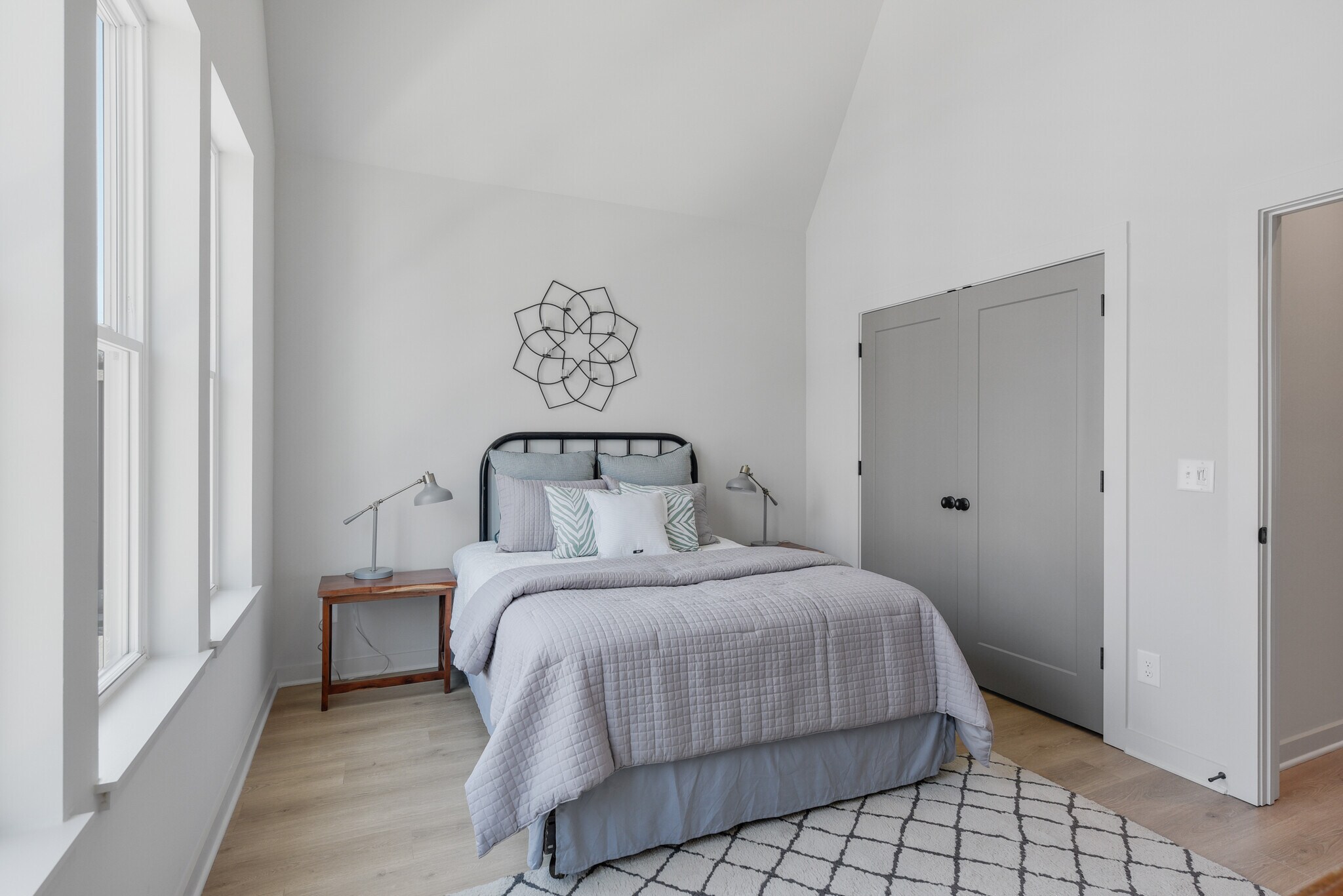 Light-filled secondary bedroom with soaring ceilings, generous closet space, and serene design. - 358 E Village Ln