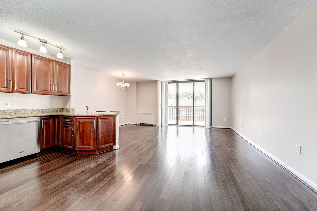 Spacious living and dining room areas with hardwood flooring! - 4242 East West Hwy