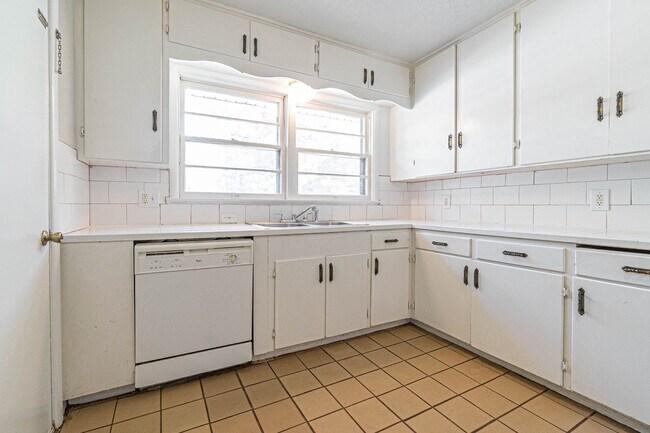 Building Photo - Three Bedroom Home in tree filled neighborhood! Lawn care included!