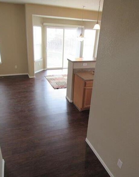 Hardwood floors leading out to backyard. - 7334 Pearly Heath Rd