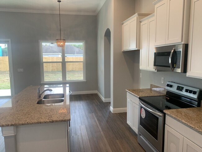 Building Photo - "Spacious 4-Bedroom 3-Bath with In-Law Suite & Granite Finishes in Palm Bay!"