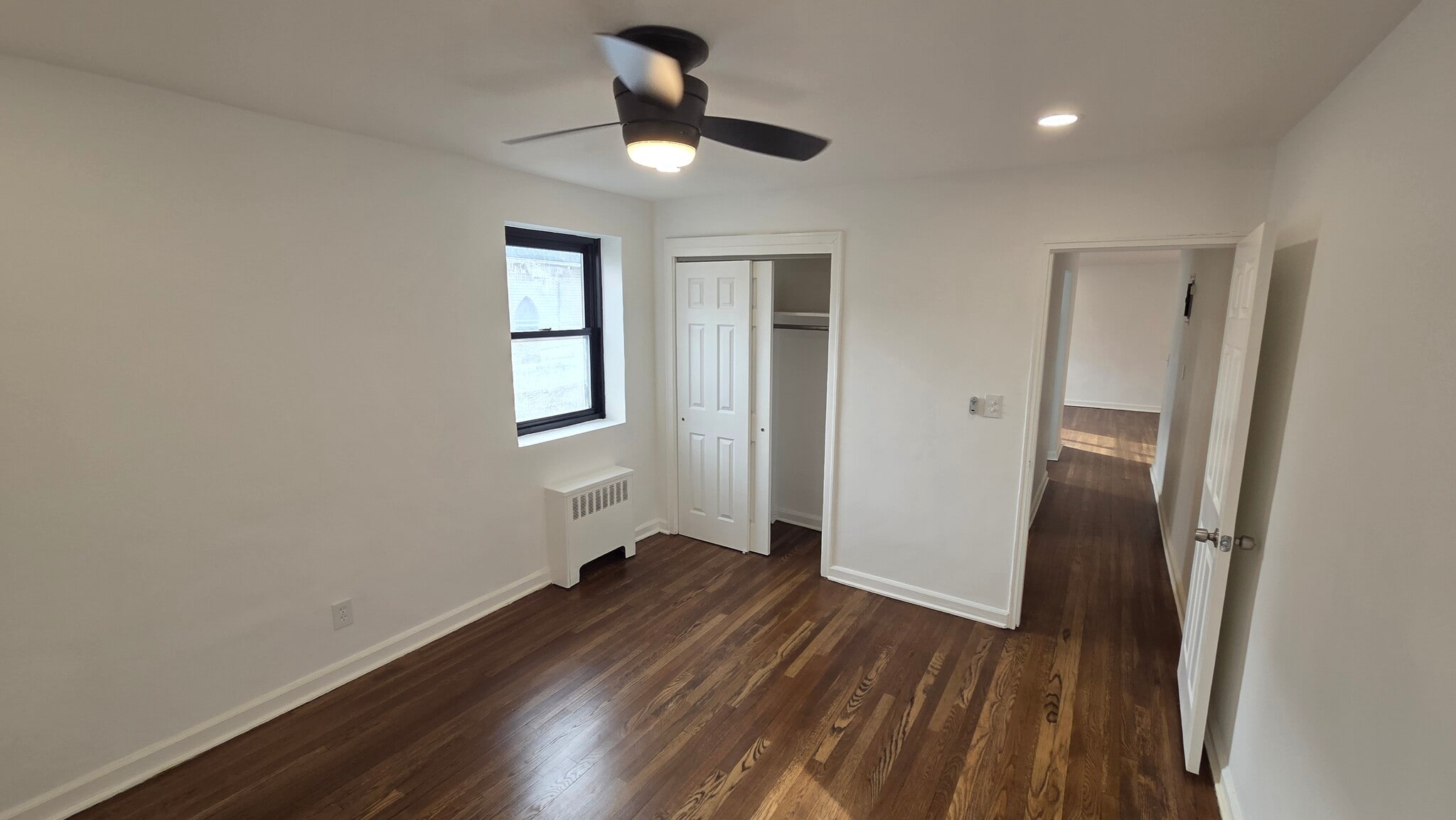 Bedroom with large closet and refinished hardwood floors - 165 Vroom St