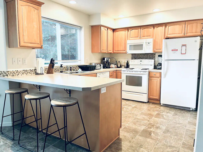 Roomy Kitchen with lots of cabinet space and full size pantry - 244 SW Moorea Ln