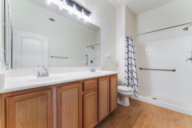 Building Photo - Charming Ground-Floor Condo with Wood Flooring & Modern Comforts!