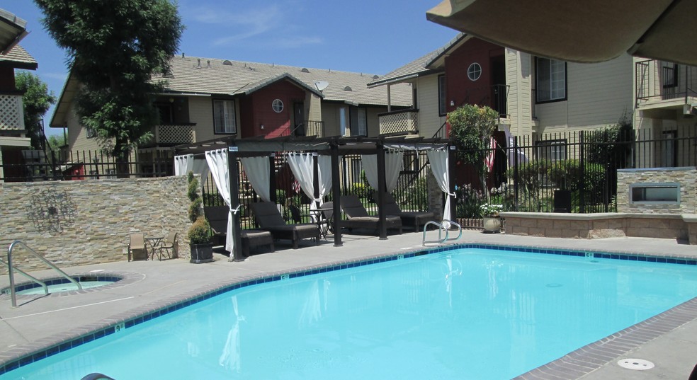 1 of 2 pool areas w/fireplace - Whispering Meadows Apartments and Suites