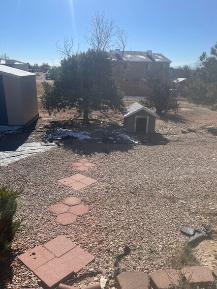 Backyard is spacious and even has a dog house built for your furry friends - 240 W Kyle Dr