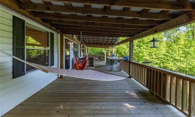 Deck space with hammock, fireplace, and general hangout. - 511 Leon Coffey Rd
