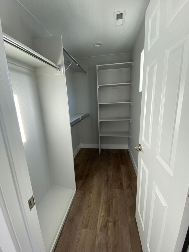 Primary Bedroom Walk-in Closet with Window - 1130 Swope Ave