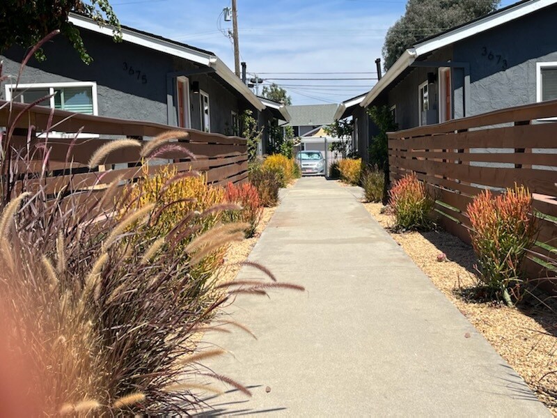 Walkway through complex to the back parking area. - 3673 Cherokee Ave