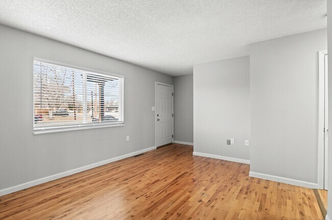 Experience natural light and warmth in this welcoming living room, perfect for relaxation. - 5580 West 4th Avenue Townhomes