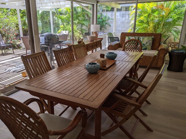 Dining area with teak furniture and private garden view - 426 Ilimano St