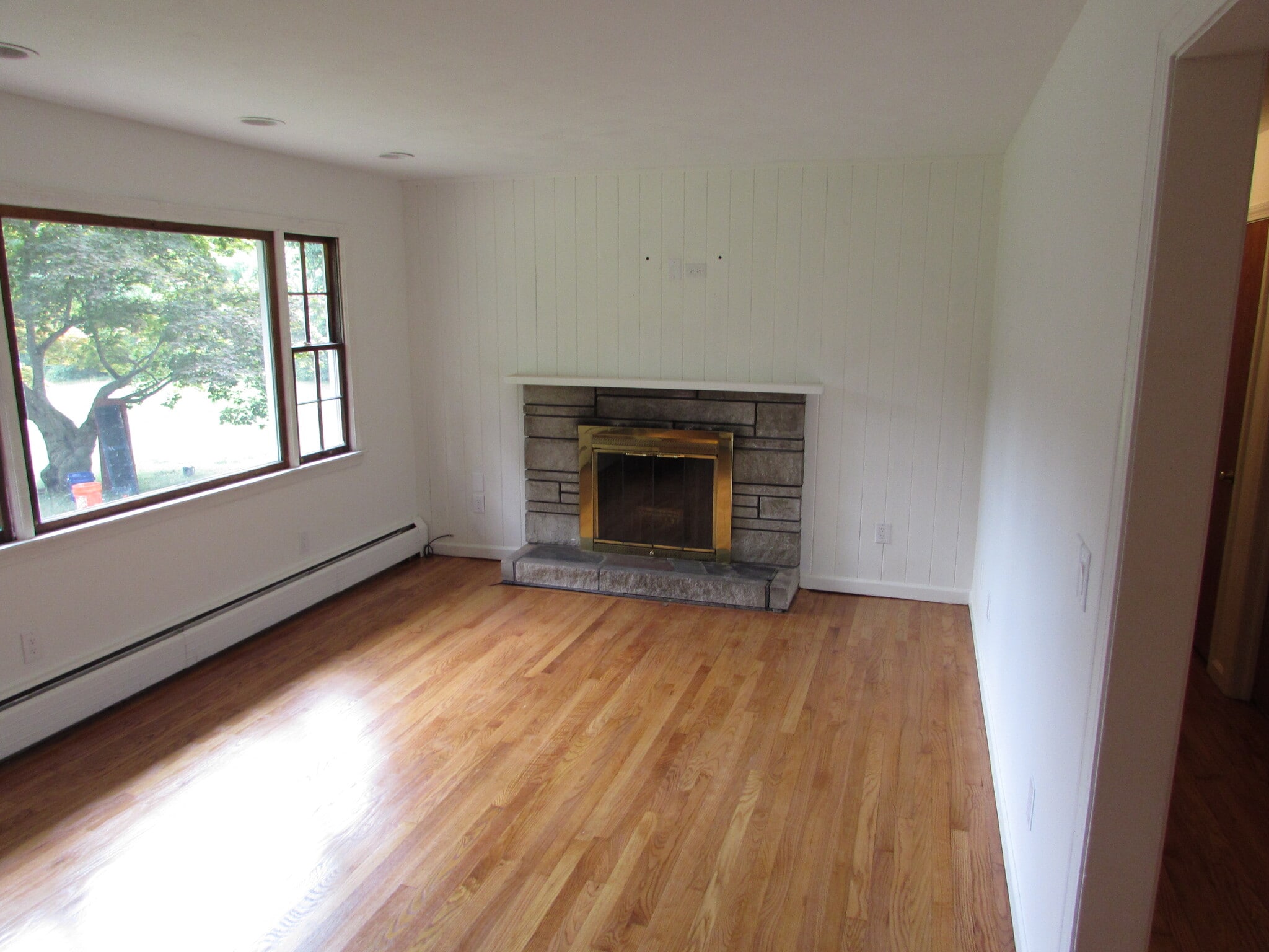 Fireplace with picture window in living room - 97 Scrub Oak Rd