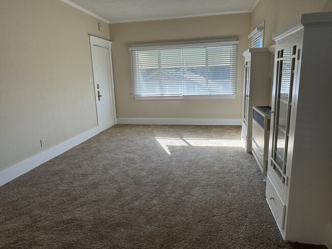 Newly renovated living room as viewed from the kitchen entrance. Light & bright South facing window - 1749 E 3rd St