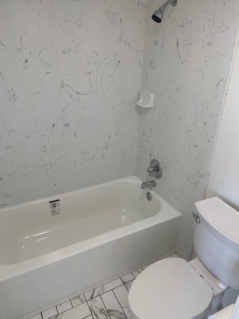 New tub, toilet, shower walls, and tile flooring - 2100 Date St