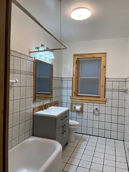 The Medicine cabinet opens and has storage. There is one window in the bathroom. - 7619 S Phillips Ave