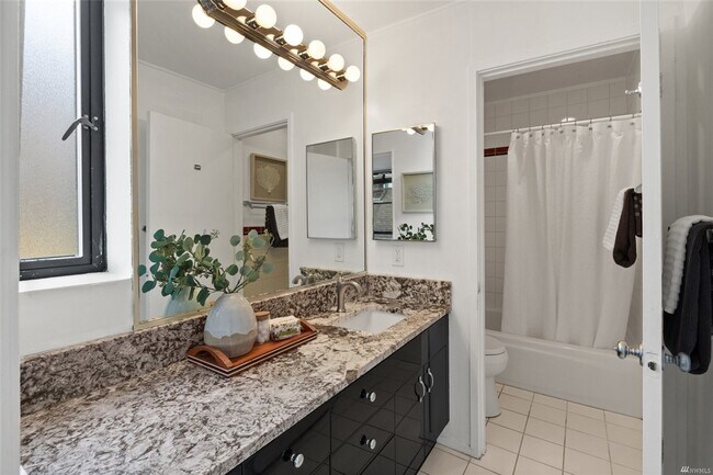 New slab counters and all tile bath with vaudeville makeup lights, lots of counter space - 730 Bellevue Ave E