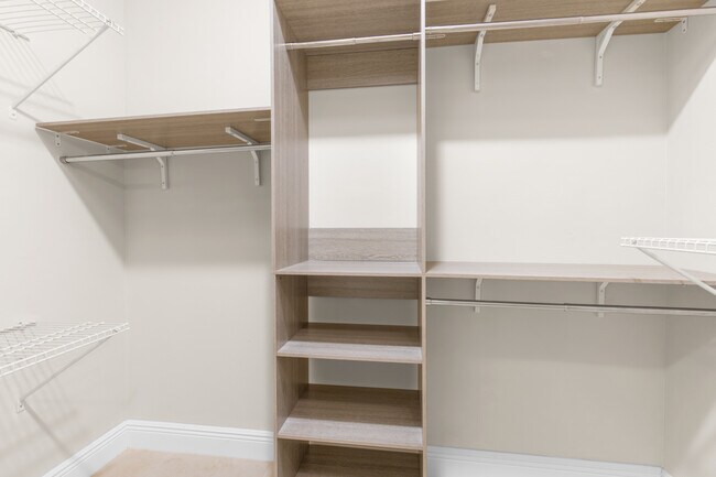 Custom walk-in closet shelving in master bedroom - 4400 Vanda Dr