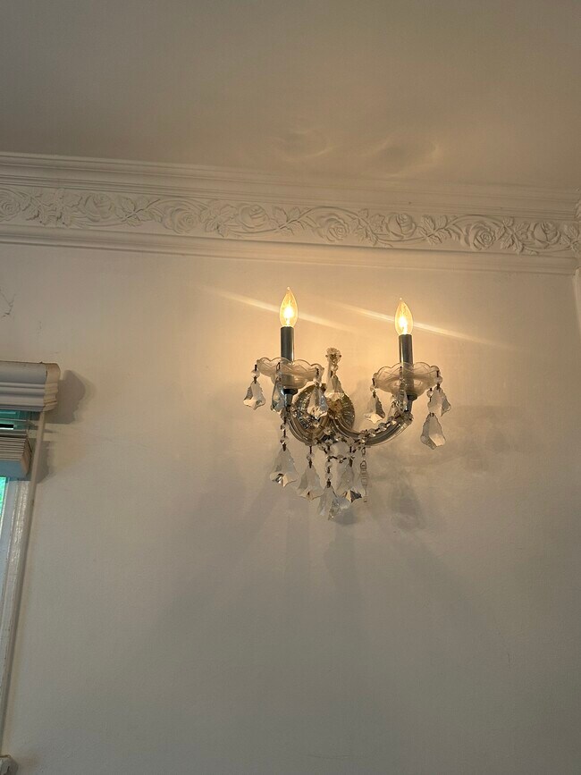 Matching wall sconces, add additional charm to the bedroom, and highlight the crown molding. - 1857 Pandora Ave