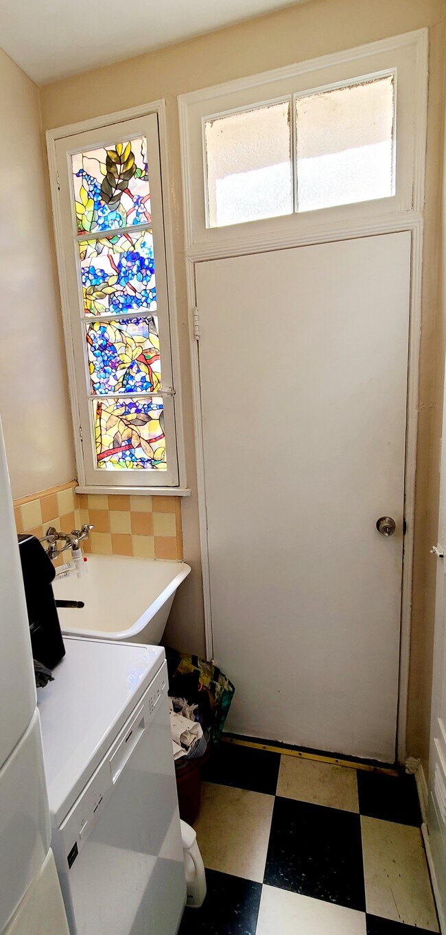 Utility sink in laundry room. Stained glass window. Lots of vintage character. - 1003 S Holt Ave