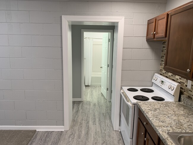 looking down hallway into bathroom - 705 Peach Tree Ln