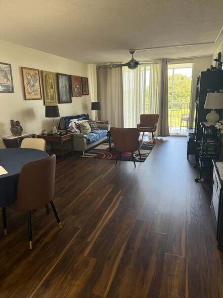 Living room and balcony - 2901 S Palm Aire Dr