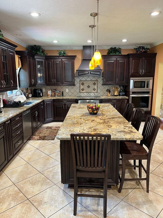 Building Photo - Updated & Landscaped 4 Bedroom, 4 Bath Hom...