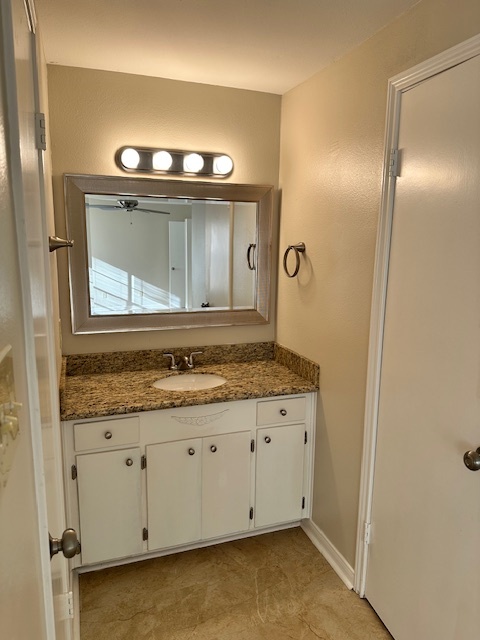 Primary suite vanity area with granite counters and undermount sink - 128 Dallas St