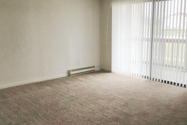 Living area with Sliding Door and Blinds - Countryside Apartments