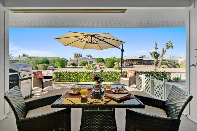 Enjoy morning pastries or an afternoon grill out on your covered patio. - 12414 W Nugget Ct