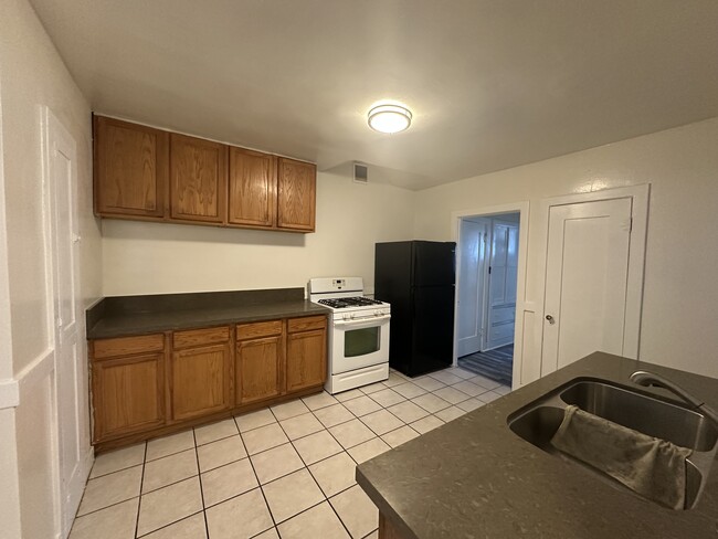 Granite countertops and wood cabinets - 902 W 73rd St