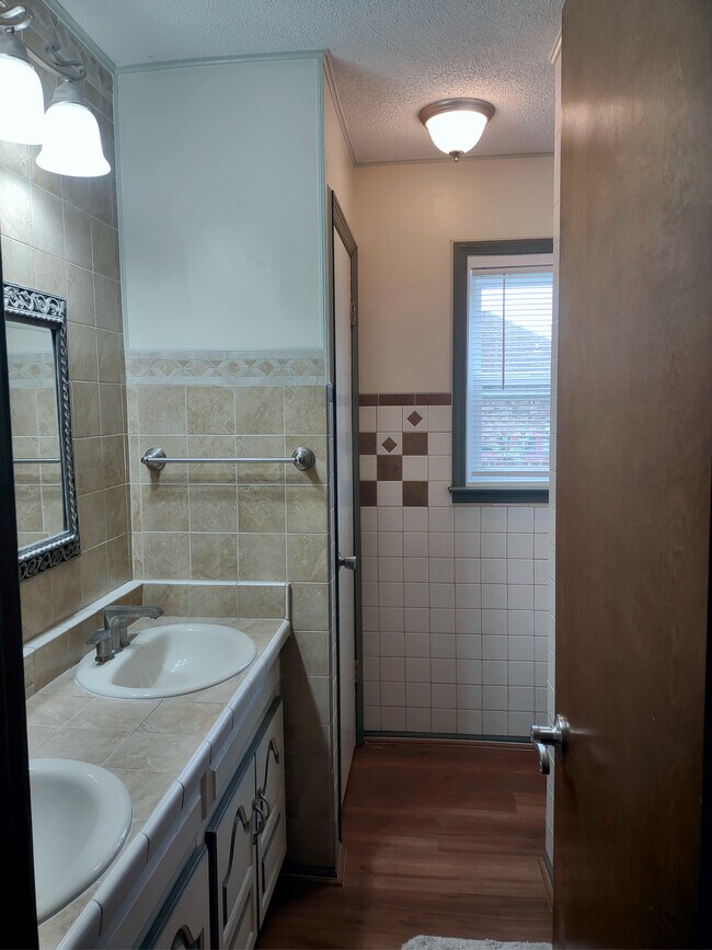 Maine bathroom with double ceramic-stone tiled vanity. - 120 Arrow Lands Trl