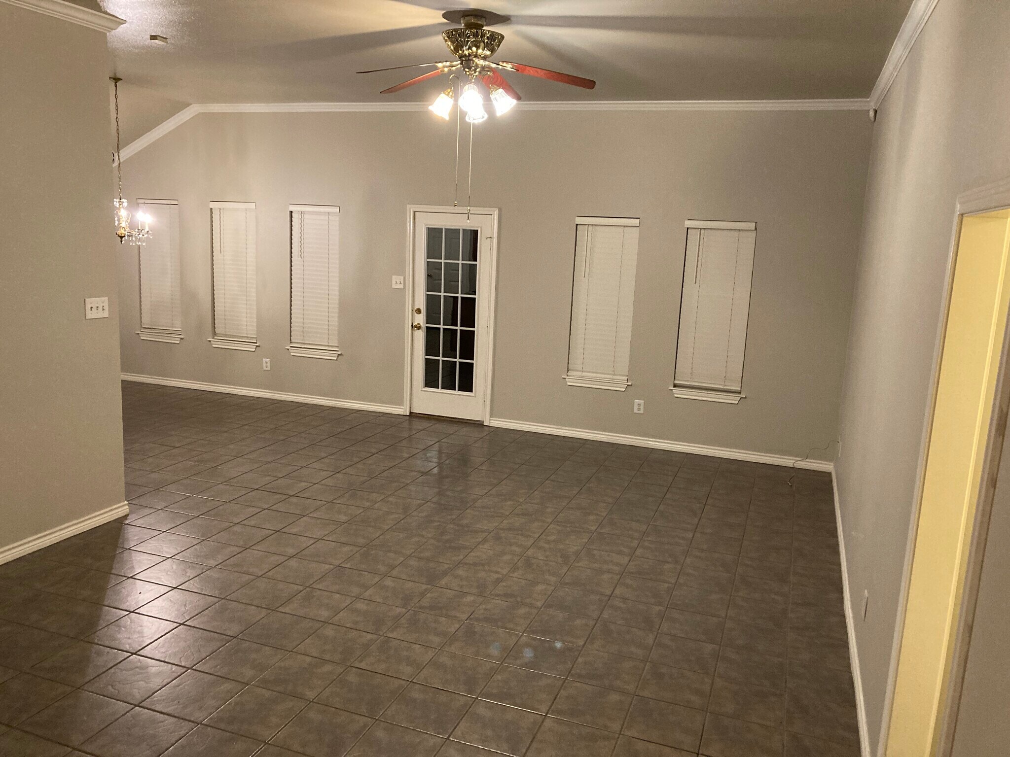 Ample open concept living room & dining area with crown molding. - 16485 County Road 164