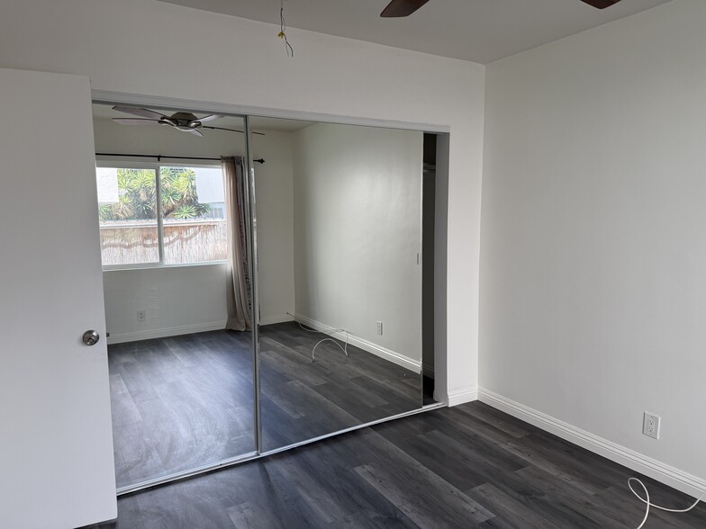 Bedroom with new floor and paint, and large closet with sliding mirror doors - 5462 Barton Ave