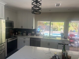 shared kitchen in the house with pool/hot tub in background - 7073 Mewall Dr