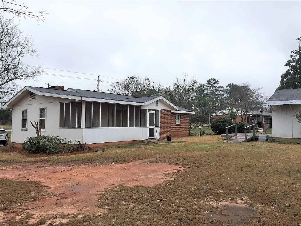 back yard partially fenced with large storage shed and deck - 407 Collins Ave