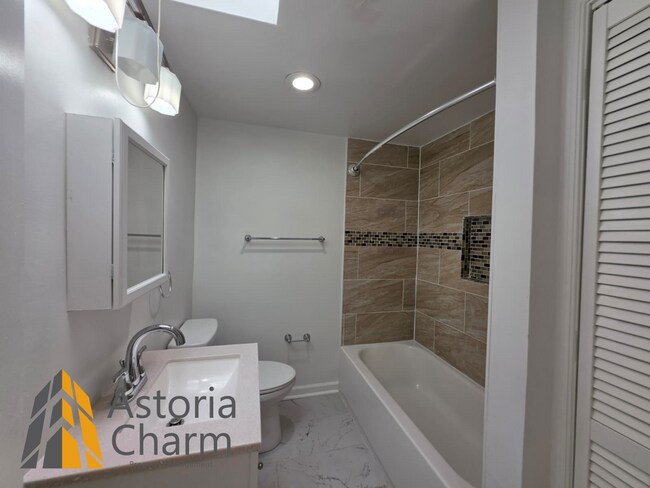 Building Photo - 3 Bedroom End Unit with Finished Basement and Fenced Yard on E 28th Street