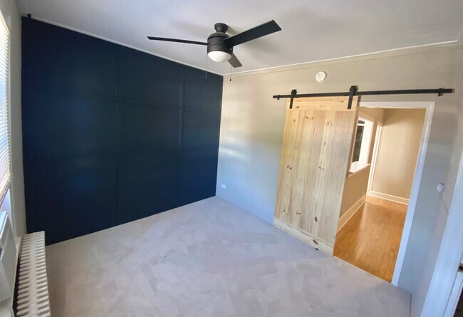 Bedroom with Accent Wall and Barn Door - 119 W State St