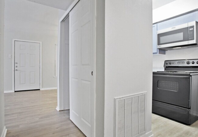 Spacious Living Area – Open floor plan with wood-style flooring in Terrell TX - Adelaide