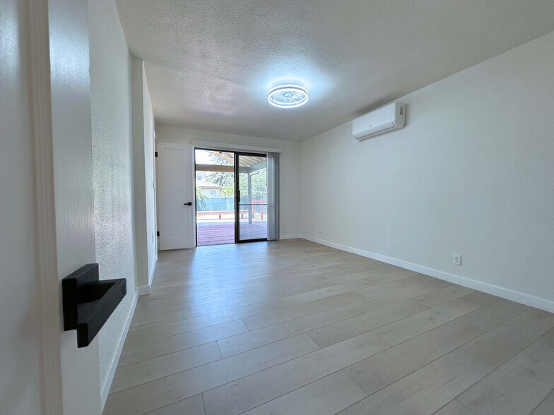 Spacious second bedroom easily fits a king bed, features a closet and sliding door with patio access - 4570 58th St