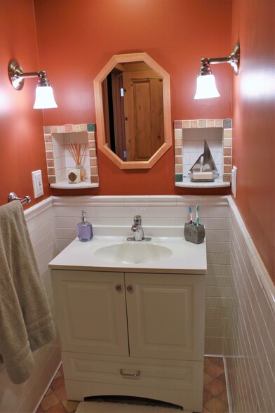 Bathroom has lots of storage with under-the-sink cabinet and linen closet - 1236 Northeast 103rd Street