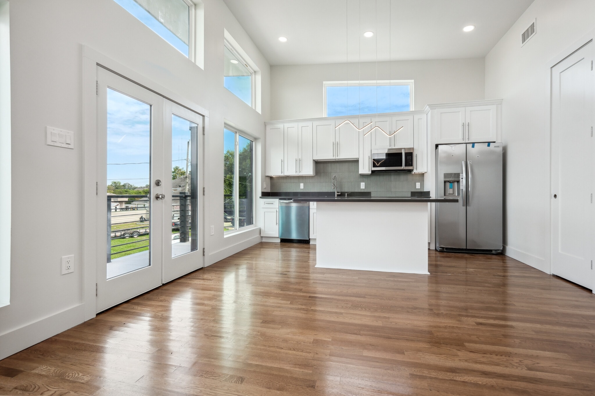 Kitchen with custom cabinetry, quartz countertops and stainless steel appliances - 428 W Solidelle St