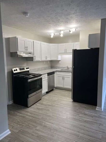 Elevate your living standards at Arbor Terrace with this modern kitchen featuring sleek cabinetry and state-of-the-art appliances. Perfect for culinary creations and everyday convenience. Schedule a tour today to see it for yourself! - Arbor Terrace