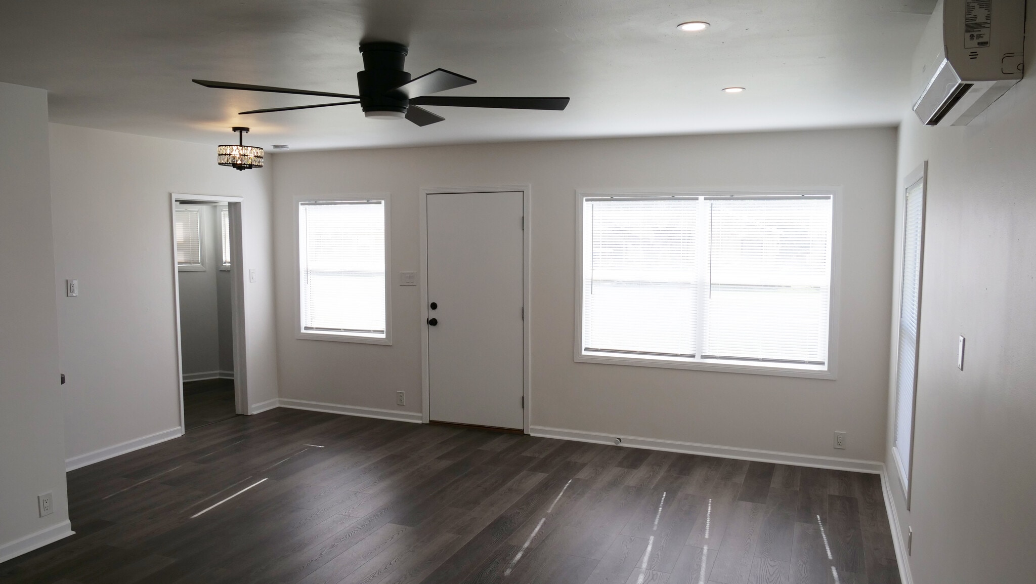 Living space view of front door and entrance to kitchen. Natural sunlight and recessed lighting - 259 E Puente St