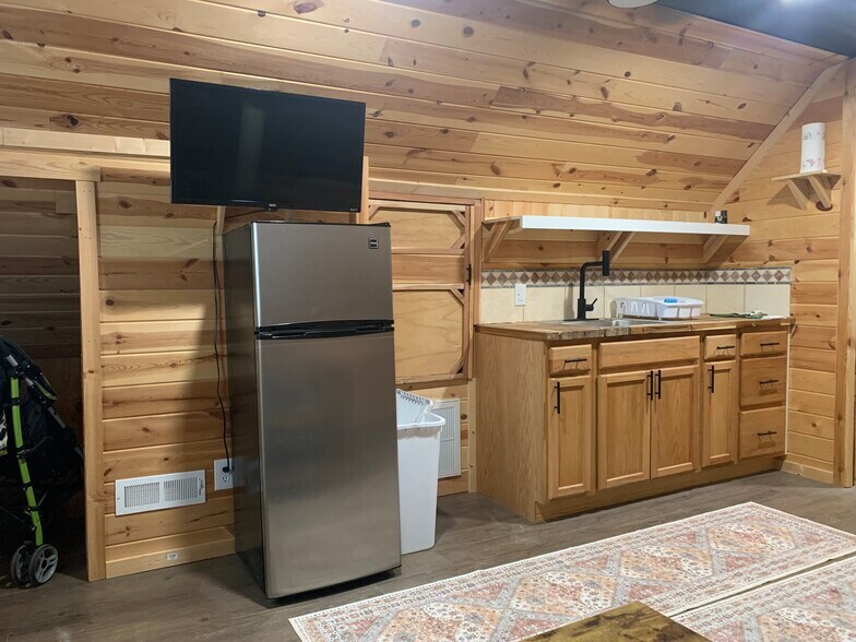 TV above decent size fridge, pantry, larder, kitchen sink and cabinets with pots, pans, plates etc - 135 Lock Seven Ln